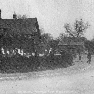 Children around pump on Home Green